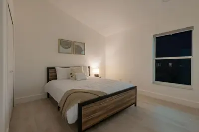 a bedroom with a large bed with a window at Resort-Style Home Near Disney | Pool | Game Room in Kissimmee