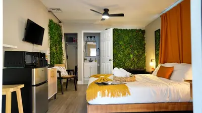 a hotel room with a bed and a kitchen with a kitchen at Quiet Boho Suite near Orlando attractions in Orlando