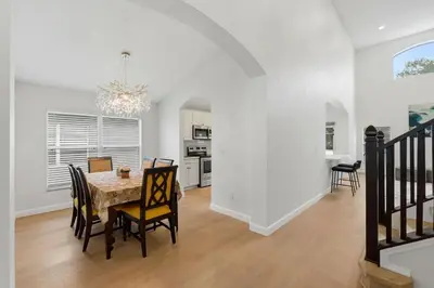 a dining room and kitchen with a table and chairs at The Seasons Retreat 5BR Oasis with Private Pool in Kissimmee