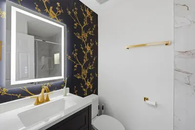 a bathroom with a sink and a mirror at The Seasons Retreat 5BR Oasis with Private Pool in Kissimmee