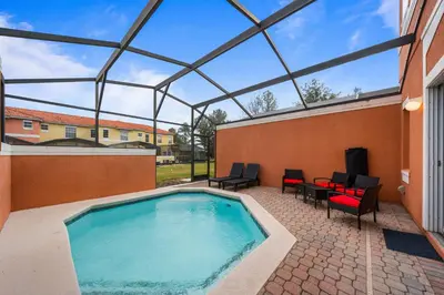 a large swimming pool with a glass roof at 8564 Bay Lilly Loop in Kissimmee