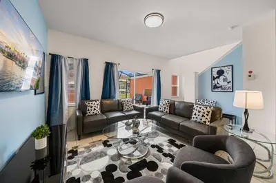 a living room with couches and a glass table at 8564 Bay Lilly Loop in Kissimmee