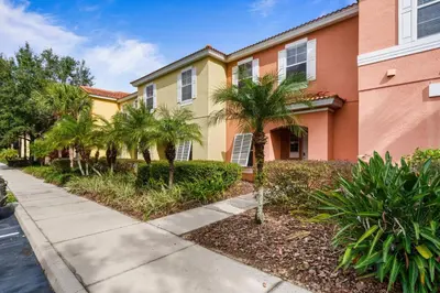 a house with palm trees and a sidewalk at 8564 Bay Lilly Loop in Kissimmee