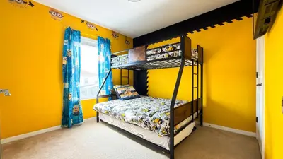 a bedroom with two bunk beds in a yellow wall at Stylish 4BR Townhome Private Pool BBQ & Near Disney in Kissimmee