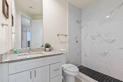 a bathroom with a sink and a toilet and a shower at 5 Suites Sleeps 14 Lion King Mickey Theme in Orlando