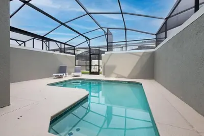 a swimming pool in a building with a glass ceiling at Casa 4Q Chic Storey Lake - Perto Disney in Kissimmee