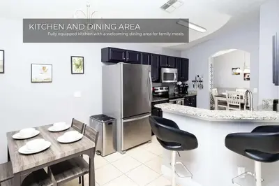 a kitchen and dining area with a stainless steel refrigerator at 5BRDisney Villa Pool,Game Room & Resort Access in Kissimmee