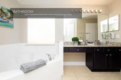 a bathroom with a sink and a mirror at 5BRDisney Villa Pool,Game Room & Resort Access in Kissimmee