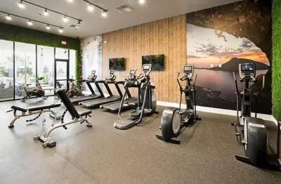a gym with a bunch of exercise bikes in a room at 4BR Disney Area Townhome - Pool, Grill & Clubhouse in Orlando