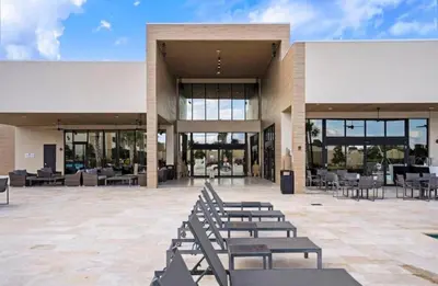 a building with a bunch of benches in front of it at 4BR Disney Area Townhome - Pool, Grill & Clubhouse in Orlando