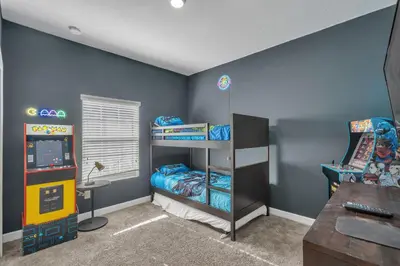 a room with two bunk beds and a video game at Kingdoms and Galaxies Luxury Villa in Kissimmee