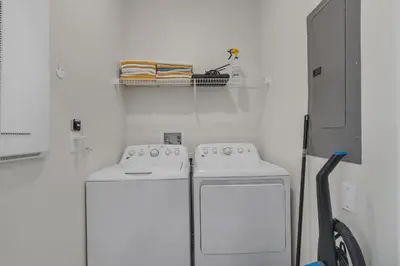 two washing machines in a room with white walls at Kingdoms and Galaxies Luxury Villa in Kissimmee