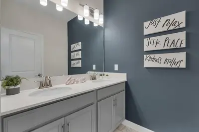 a bathroom with a sink and a mirror at Kingdoms and Galaxies Luxury Villa in Kissimmee