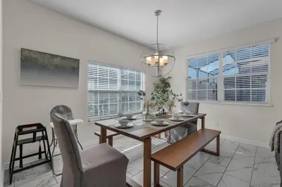 a dining room with a table and chairs at Kingdoms and Galaxies Luxury Villa in Kissimmee