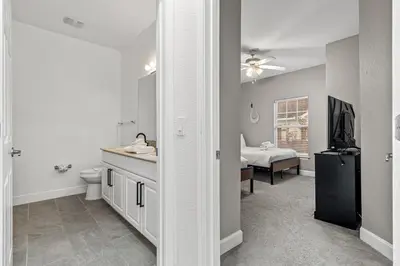 a bathroom with a sink and a toilet in a room at Near Disney! Kissimmee Home for 12 w/ Pool Access! in Kissimmee