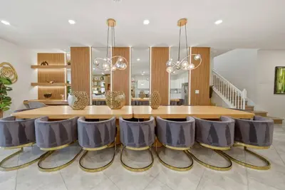 a dining room with a table and chairs at Brand NEW 10Bdrms8Bath Luxury in Orlando