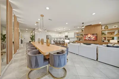 a dining room with a long table and chairs at Brand NEW 10Bdrms8Bath Luxury in Orlando