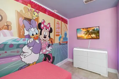 a bedroom with a mickey mouse mural on the wall at Disney Heated Pool & Arcade Home 15 mins to Park in Kissimmee
