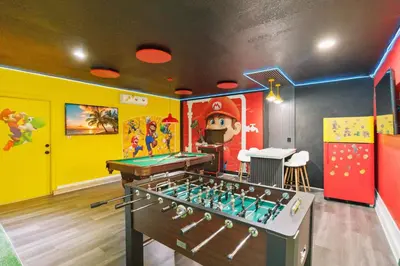 a childrens room with a pool table and a game at Disney Heated Pool & Arcade Home 15 mins to Park in Kissimmee