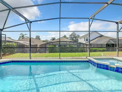 a large swimming pool with blue water at Holiday Home Familien-Pool-Rückzug nur 2-5 Meilen von Disney entfernt by Interhome in Kissimmee