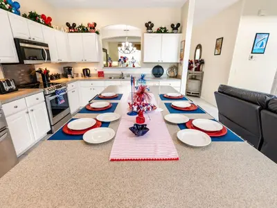 a kitchen with a table with red and blue plates on it at Holiday Home Ferienvilla Magical Memories by Interhome in Kissimmee