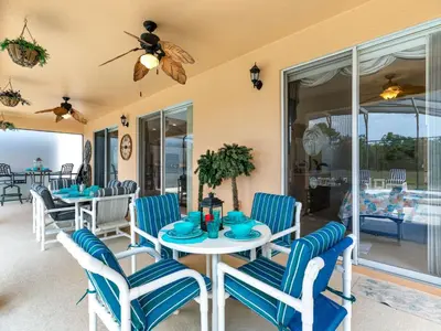 a dining room with blue and white chairs and a table at Holiday Home Ferienvilla Magical Memories by Interhome in Kissimmee