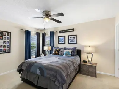 a bedroom with a bed and a ceiling fan at Holiday Home Ferienvilla Magical Memories by Interhome in Kissimmee