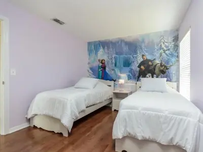 a bedroom with two beds and a painting on the wall at Holiday Home 2696LIC by Interhome in Kissimmee