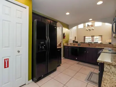 a kitchen with black appliances and a black refrigerator at Holiday Home Villa mit 6 Schlafzimmern und atemberaubendem Seeblick by Interhome in Kissimmee