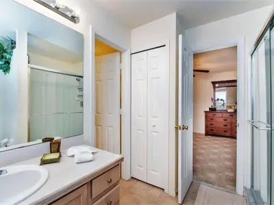 a bathroom with a sink and a mirror at Holiday Home Ausgezeichnetes Preis-Leistungs-Verhältnis Familienvilla - Süd-West Privater Po by Interhome in Kissimmee