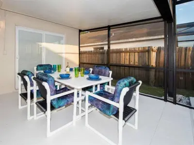a dining room with a white table and chairs at Holiday Home Ausgezeichnetes Preis-Leistungs-Verhältnis Familienvilla - Süd-West Privater Po by Interhome in Kissimmee