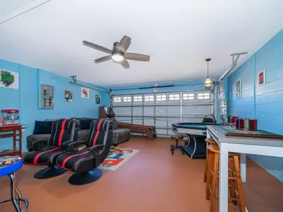 a living room with a ping pong table at Holiday Home Moderne Villa mit Seeblick nur wenige Minuten von Disney entfernt by Interhome in Kissimmee