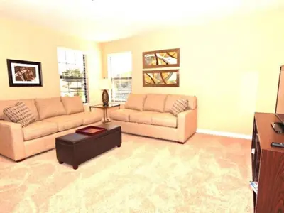a living room with two couches and a tv at Holiday Home 3-Schlafzimmer Value Plus Haus mit privatem Pool by Interhome in Kissimmee