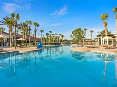 a large pool with palm trees in a resort at Apartment Wasserpark Fantastischer Pool Nur wenige Minuten von Disney Parks entfernt by Interhome in Orlando