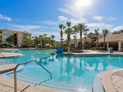a large swimming pool at a resort with palm trees at Apartment Wasserpark Fantastischer Pool Nur wenige Minuten von Disney Parks entfernt by Interhome in Orlando