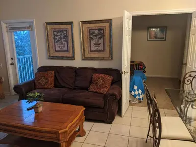 a living room with a couch and a table at Apartment Wasserpark Fantastischer Pool Nur wenige Minuten von Disney Parks entfernt by Interhome in Orlando