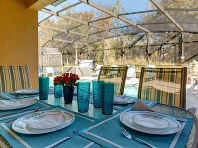 a table with plates and vases on top at Holiday Home Luxuriöse 4-Bett-Villa in Disney by Interhome in Kissimmee