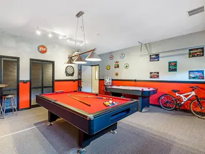 a billiard room with a pool table and a bike at Holiday Home Florida Breeze mit Whirlpool by Interhome in Kissimmee