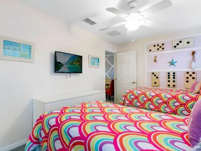 a childs bedroom with a colorful bed at Holiday Home Florida Breeze mit Whirlpool by Interhome in Kissimmee