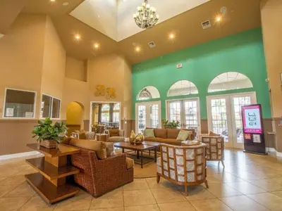 a lobby with couches and tables and windows at Holiday Home Florida Breeze mit Whirlpool by Interhome in Kissimmee