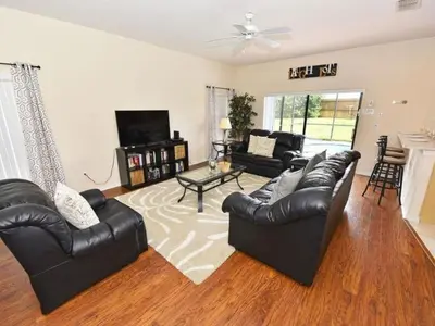 a living room with leather couches and a tv at Holiday Home Villa Glenbrook Resort by Interhome in Orlando