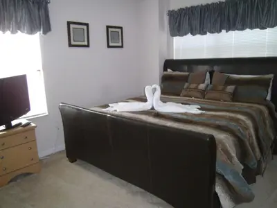 a bedroom with a large bed with two swans on it at Holiday Home Villa Glenbrook Resort by Interhome in Orlando