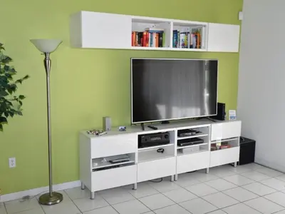 a living room with a television on a white entertainment center at Holiday Home Familienfreundliche Villa nahe der Disney-Parks by Interhome in Orlando