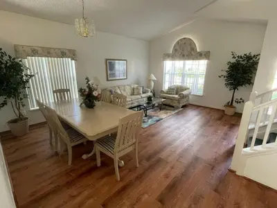 a living room with a table and chairs and a couch at Holiday Home Familienfreundliche Villa nahe der Disney-Parks by Interhome in Orlando