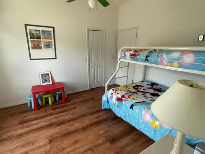 a bedroom with a bunk bed and a table at Holiday Home Familienfreundliche Villa nahe der Disney-Parks by Interhome in Orlando