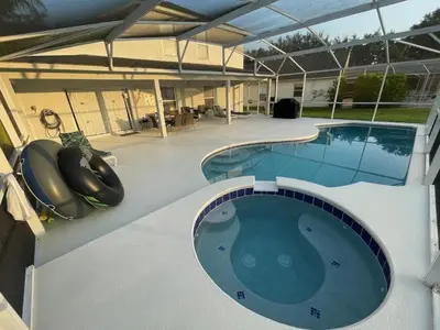 a large swimming pool in a building with a swimming simulator at Holiday Home Familienfreundliche Villa nahe der Disney-Parks by Interhome in Orlando