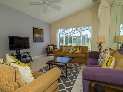 a living room with couches and a flat screen tv at Holiday Home Ruhige Glenbrook-Flucht in der Nähe von Disney by Interhome in Orlando