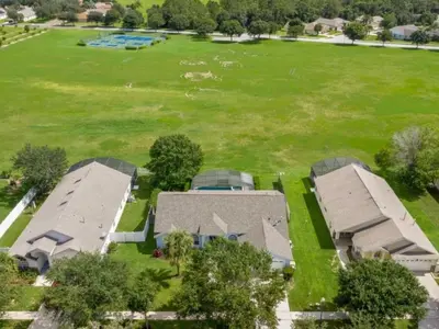 an aerial view of a house with a large field at Holiday Home Entspannende Familienvilla mit privatem Pool und Spa- Große Lanai mit reichlich by Interhome in Orlando