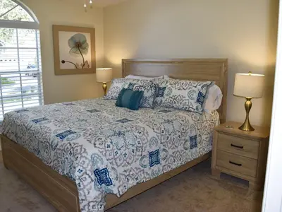 a bedroom with a bed and a lamp and a window at Holiday Home Entspannende Familienvilla mit privatem Pool und Spa- Große Lanai mit reichlich by Interhome in Orlando