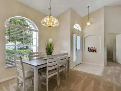 a dining room with a table and chairs at Holiday Home Entspannende Familienvilla mit privatem Pool und Spa- Große Lanai mit reichlich by Interhome in Orlando